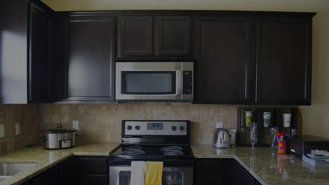 Cabinets microwave stove toaster crockpot kitchen at The Estate on Third in Waco Student Accommodation