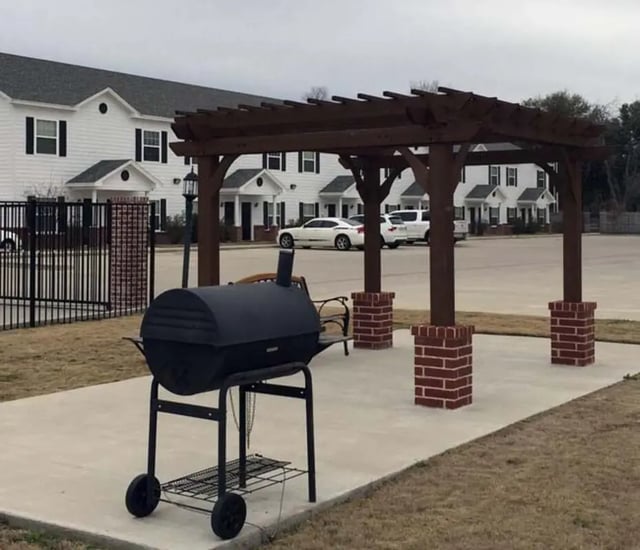Barbecue grill under wooden pergola exterior at The Estate on Third in Waco Student Accommodation