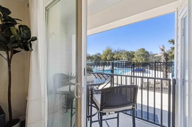 Chairs table overlooking pool exterior at The Hudson in Statesboro Student Accommodation