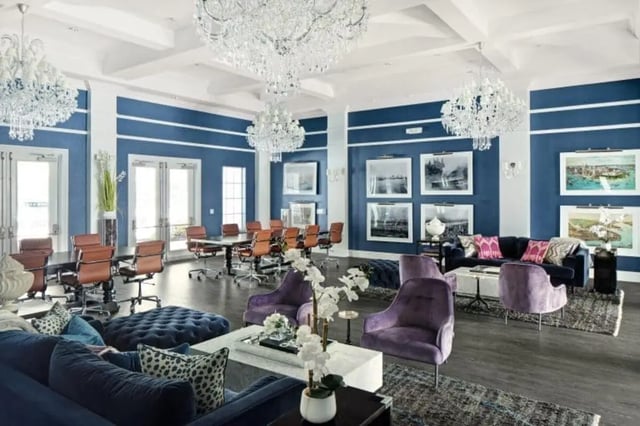 Luxury lobby with seating, tables, and chandeliers Living room at The Hudson in Statesboro Student Accommodation