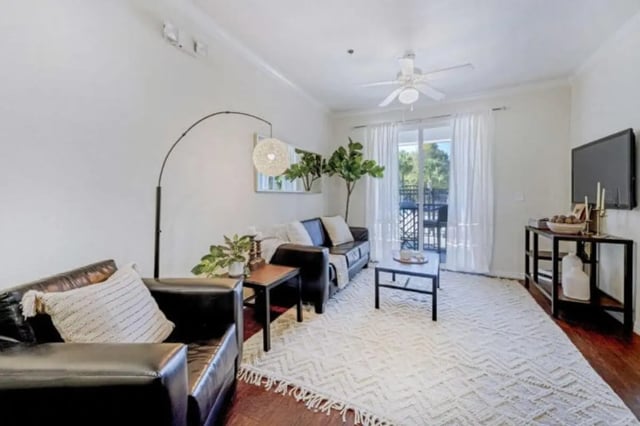 Leather couches coffee table patterned rug living room at The Hudson in Statesboro Student Accommodation