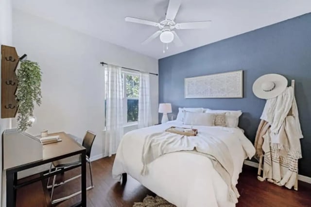 Bed desk fan with plants and white bedding bedroom at The Hudson in Statesboro Student Accommodation