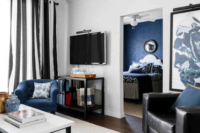 Blue armchair television and bedroom living room at The Hudson in Statesboro Student Accommodation