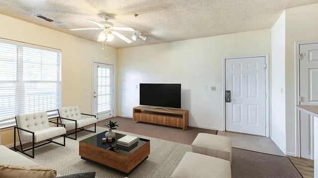 Two white chairs coffee table TV living room at Cape Trails in Cape Girardeau Student Accommodation