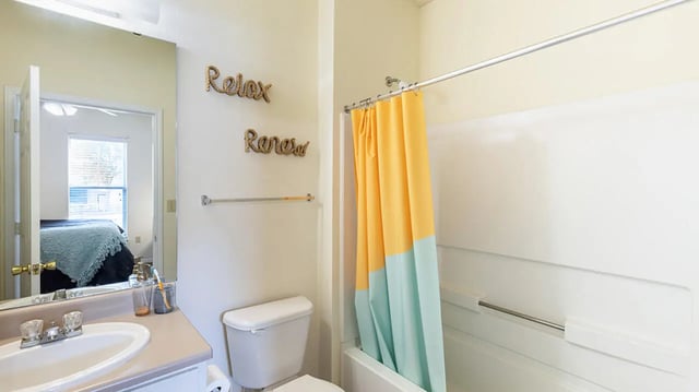 Sink toilet shower curtain mirror bedroom interior bathroom at Cape Trails in Cape Girardeau Student Accommodation
