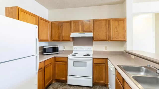 White refrigerator microwave stove sink kitchen at Cape Trails in Cape Girardeau Student Accommodation