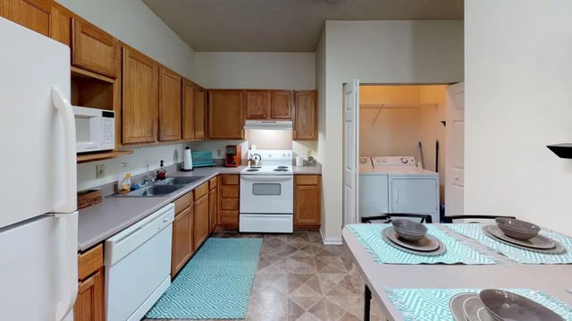 Refrigerator oven dishwasher laundry and table kitchen at Cape Trails in Cape Girardeau Student Accommodation