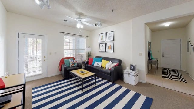Black sofas chair coffee table living room at Cape Trails in Cape Girardeau Student Accommodation