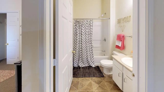 Bathroom with toilet sink and shower curtain at Cape Trails in Cape Girardeau Student Accommodation