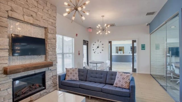 Sofa fireplace TV and table living room at Cape Trails in Cape Girardeau Student Accommodation