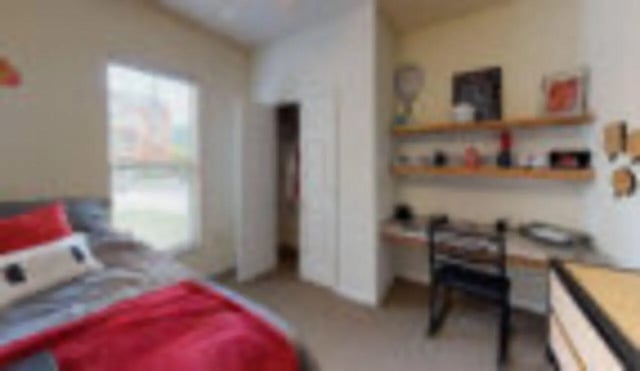 Bed with red blanket desk and shelves bedroom at Cape Trails in Cape Girardeau Student Accommodation