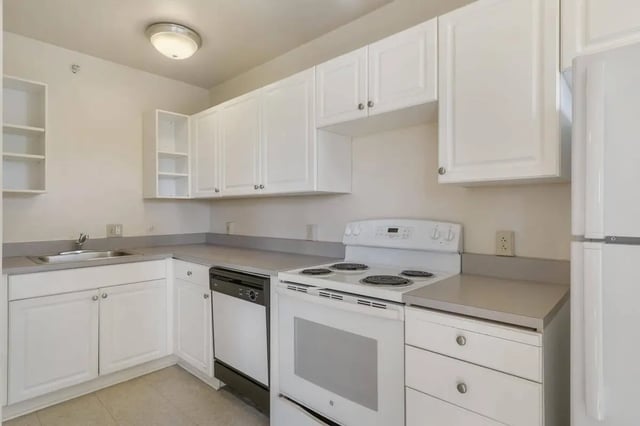 White cabinets stove sink and dishwasher kitchen at Commodore Duchess Apartments in Seattle Student Accommodation