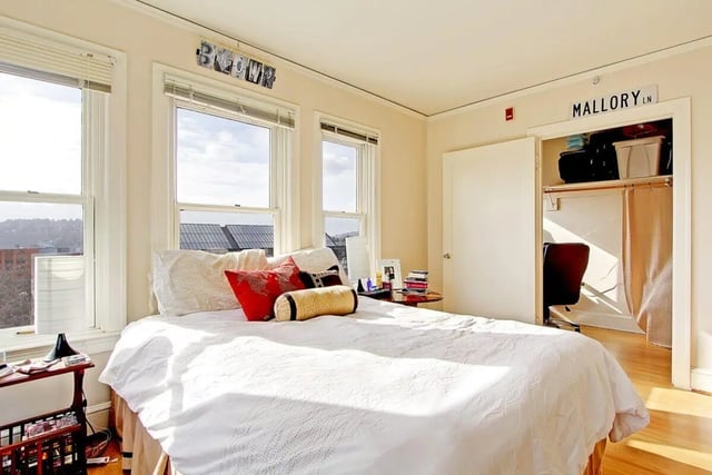 Bed with pillows and side table bedroom at Commodore Duchess Apartments in Seattle Student Accommodation
