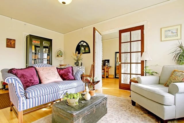Striped sofa, trunk, armchair, living room at Commodore Duchess Apartments in Seattle Student Accommodation