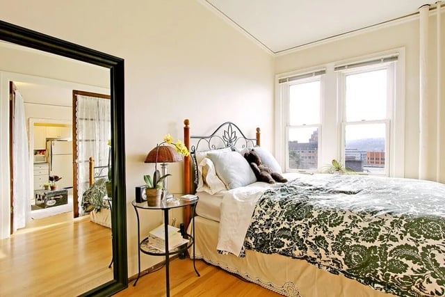 Bed with floral duvet nightstand lamp Bedroom at Commodore Duchess Apartments in Seattle Student Accommodation