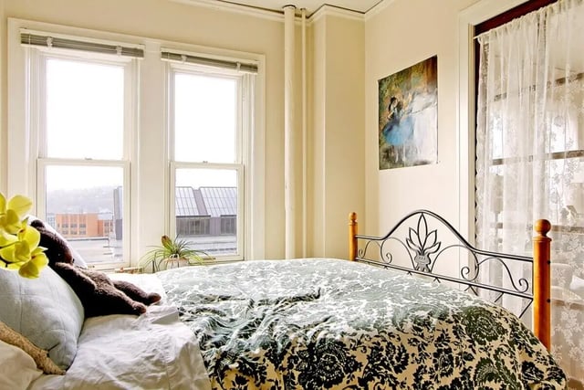 Bed with patterned duvet and floral artwork Bedroom at Commodore Duchess Apartments in Seattle Student Accommodation
