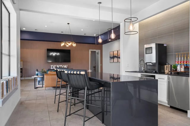 Bar stools at counter with coffee machine kitchen at Midtown 905 in Denton Student Accommodation
