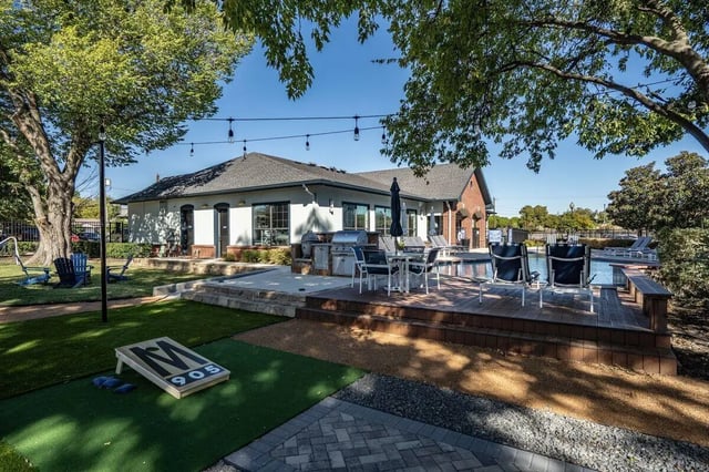 Cornhole game chairs pool and grills exterior at Midtown 905 in Denton Student Accommodation