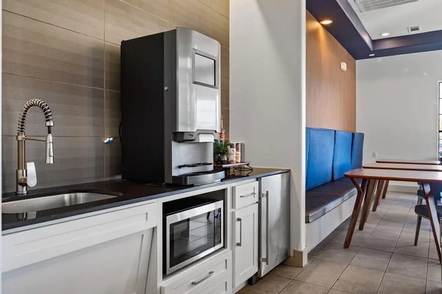 Sink microwave coffee machine seating dining area kitchen at Midtown 905 in Denton Student Accommodation