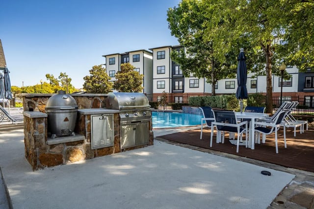 Outdoor grills pool and seating area exterior at Midtown 905 in Denton Student Accommodation