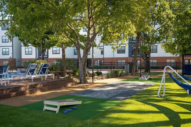 Outdoor lounge chairs games and hammock playing area at Midtown 905 in Denton Student Accommodation