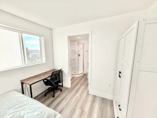 Bed desk chair and shower visible bedroom at 1329 W 36th St in Los Angeles Student Accommodation