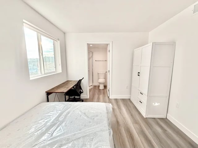 Mattress desk chair wardrobe and bathroom Bedroom at 1329 W 36th St in Los Angeles Student Accommodation