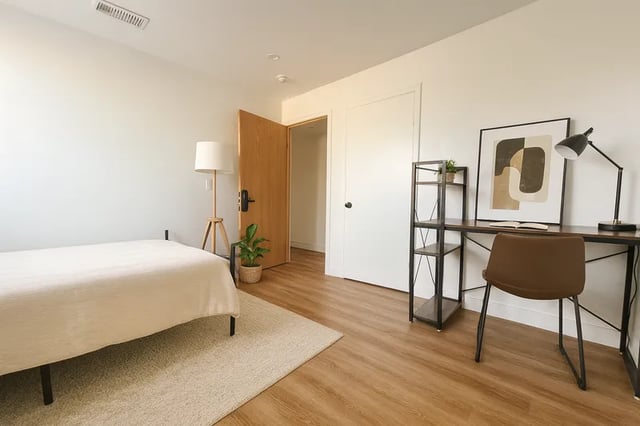 Bed desk shelf lamp artwork and chair bedroom at 1329 W 36th St in Los Angeles Student Accommodation