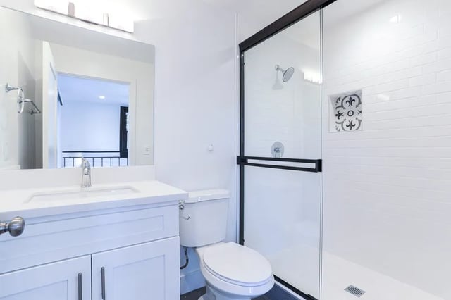 White vanity toilet shower with glass door bathroom at 1329 W 36th St in Los Angeles Student Accommodation