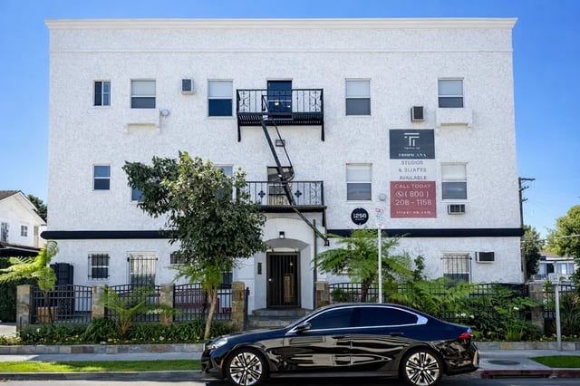 White building with fire escape and car exterior at 1329 W 36th St in Los Angeles Student Accommodation