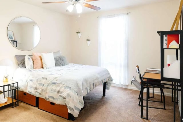 Bed desk and circular mirror bedroom at The Scarlet in Lubbock Student Accommodation