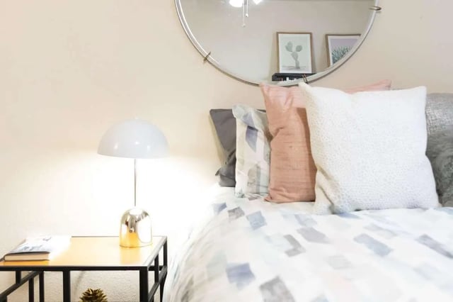 Bed with pillows lamp and artwork Bedroom at The Scarlet in Lubbock Student Accommodation