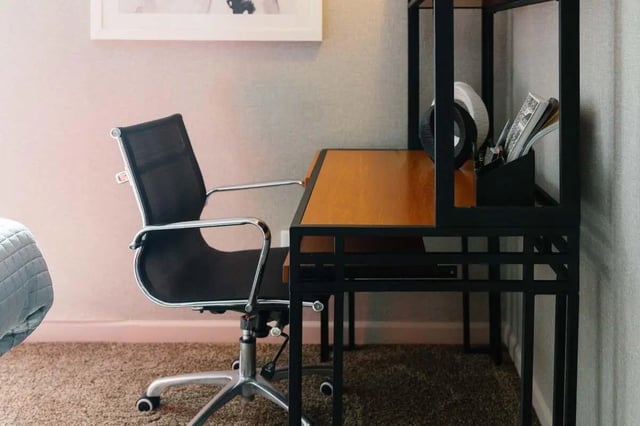 Black mesh chair with wooden desk study area at The Scarlet in Lubbock Student Accommodation