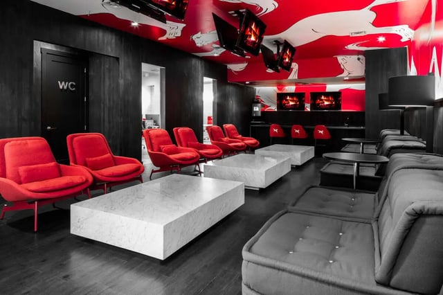 Red chairs marble tables couches living room at The Scarlet in Lubbock Student Accommodation