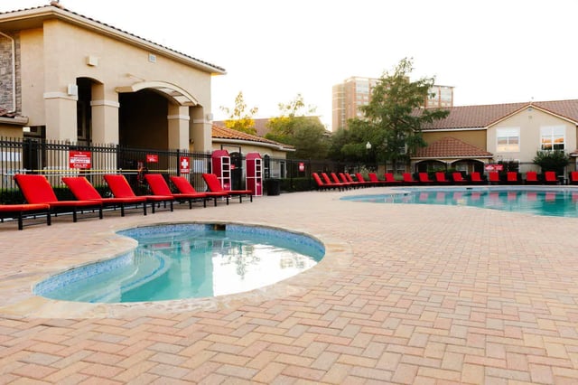 Pool area with lounge chairs exterior at The Scarlet in Lubbock Student Accommodation