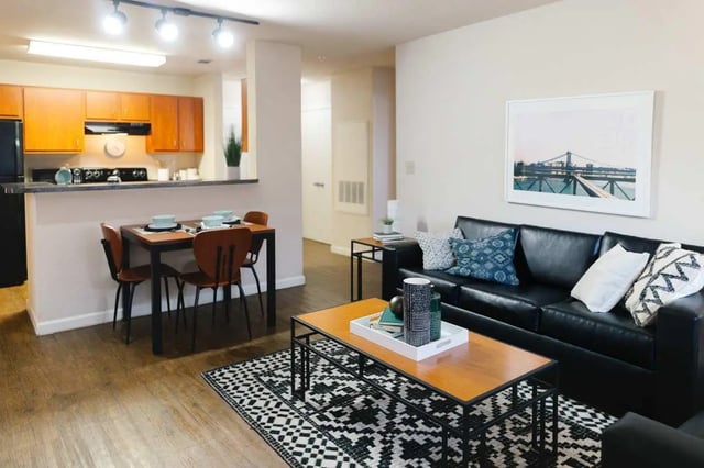 Dining table, black sofa, coffee table living room at The Scarlet in Lubbock Student Accommodation