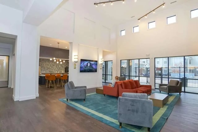 Living room with sofas and kitchen visible Living room at The Domain at Columbia in Columbia Student Accommodation