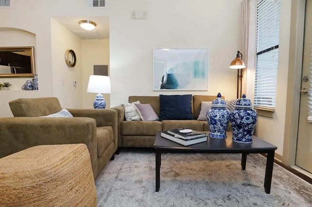 Sofa chairs coffee table with vases living room at The Domain at Columbia in Columbia Student Accommodation