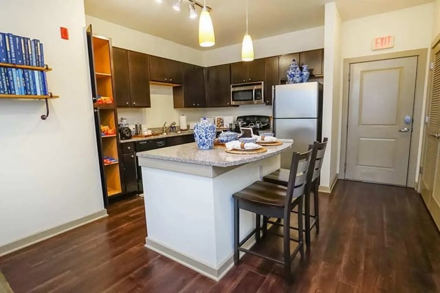 Kitchen with island two chairs and cabinets kitchen at The Domain at Columbia in Columbia Student Accommodation