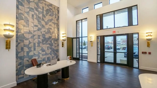 Desk with laptop patterned wall and exit doors lobby at The Domain at Columbia in Columbia Student Accommodation