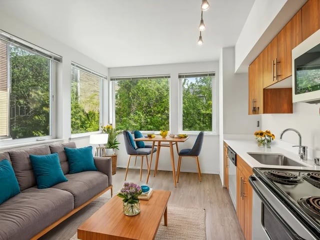 Sofa coffee table dining set modern kitchen living room at Clara Apartments in Seattle Student Accommodation