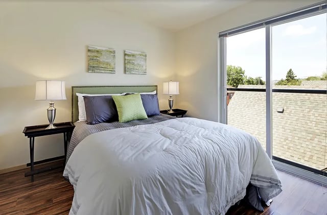 Bed with nightstands lamps art Bedroom at Clara Apartments in Seattle Student Accommodation