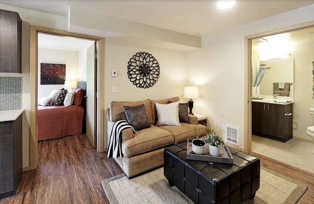 Sofa ottoman artwork opens to bedroom and bathroom Living room at Clara Apartments in Seattle Student Accommodation