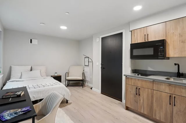 Bed chair desk microwave kitchen studio apartment at Clara Apartments in Seattle Student Accommodation