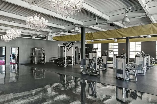 Weight machines punching bag and chandeliers gym at The Vic in Greensboro Student Accommodation