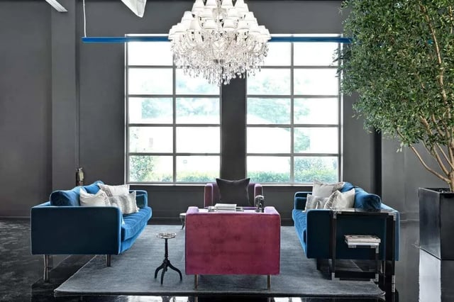 Two blue sofas a velvet chair living room at The Vic in Greensboro Student Accommodation