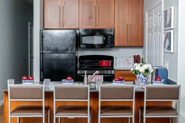 Four bar stools and kitchen counter kitchen at The Vic in Greensboro Student Accommodation