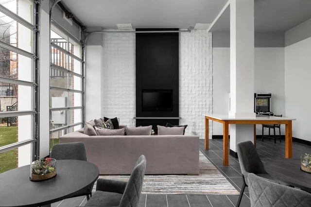 Sofa television white wall garage door living room at The Lex in Lexington Student Accommodation