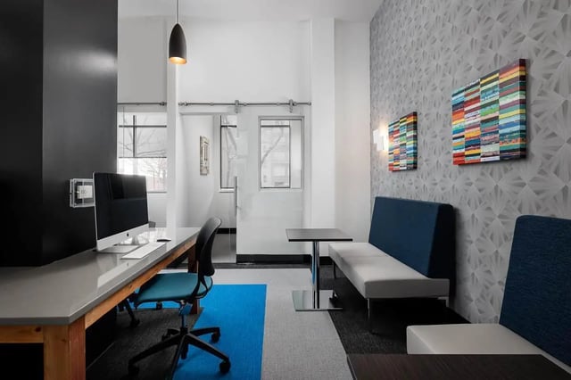 Desk computer chair and seating area common space at The Lex in Lexington Student Accommodation