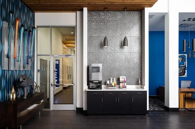 Coffee station with artwork and sculpture reception area at The Lex in Lexington Student Accommodation